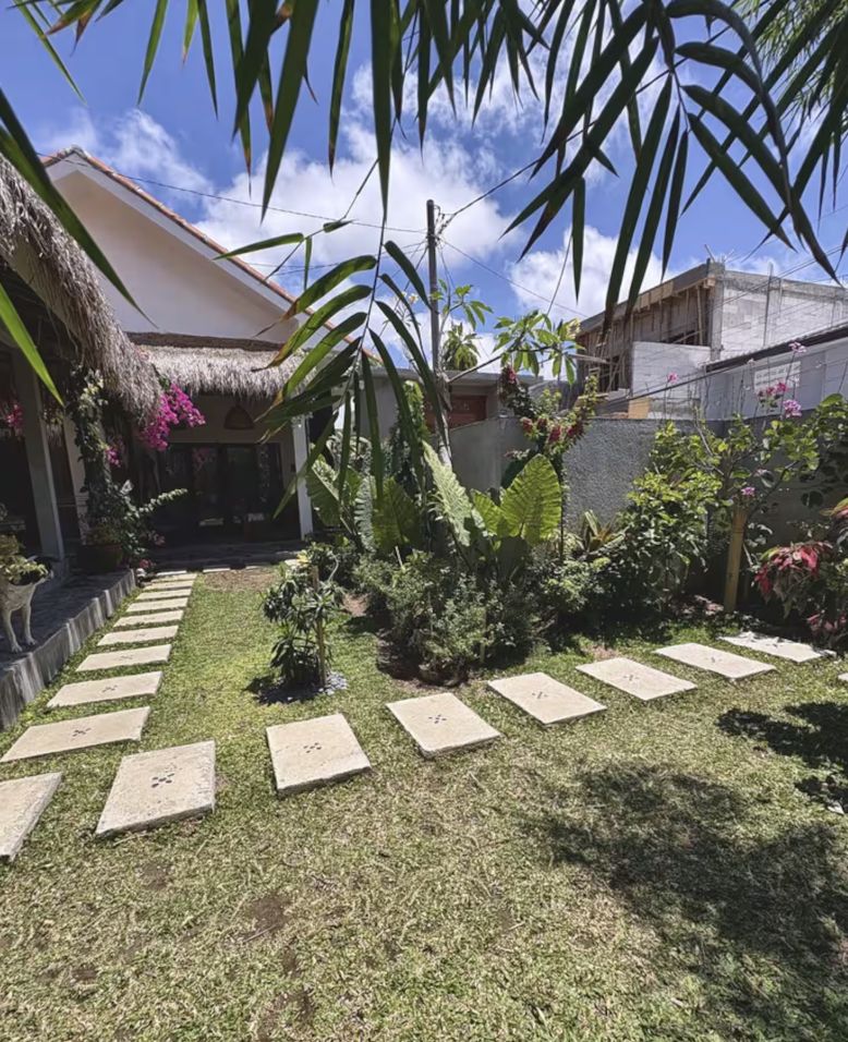 House with alang-alang roof and its garden